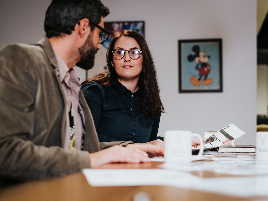 A diverse group of real estate professionals works together around a conference table, representing the collaborative power of a real estate team.