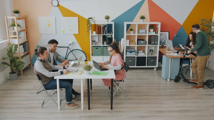 Professional solo real estate agent attentively consults with a couple in a bright, modern office, symbolizing a personali...